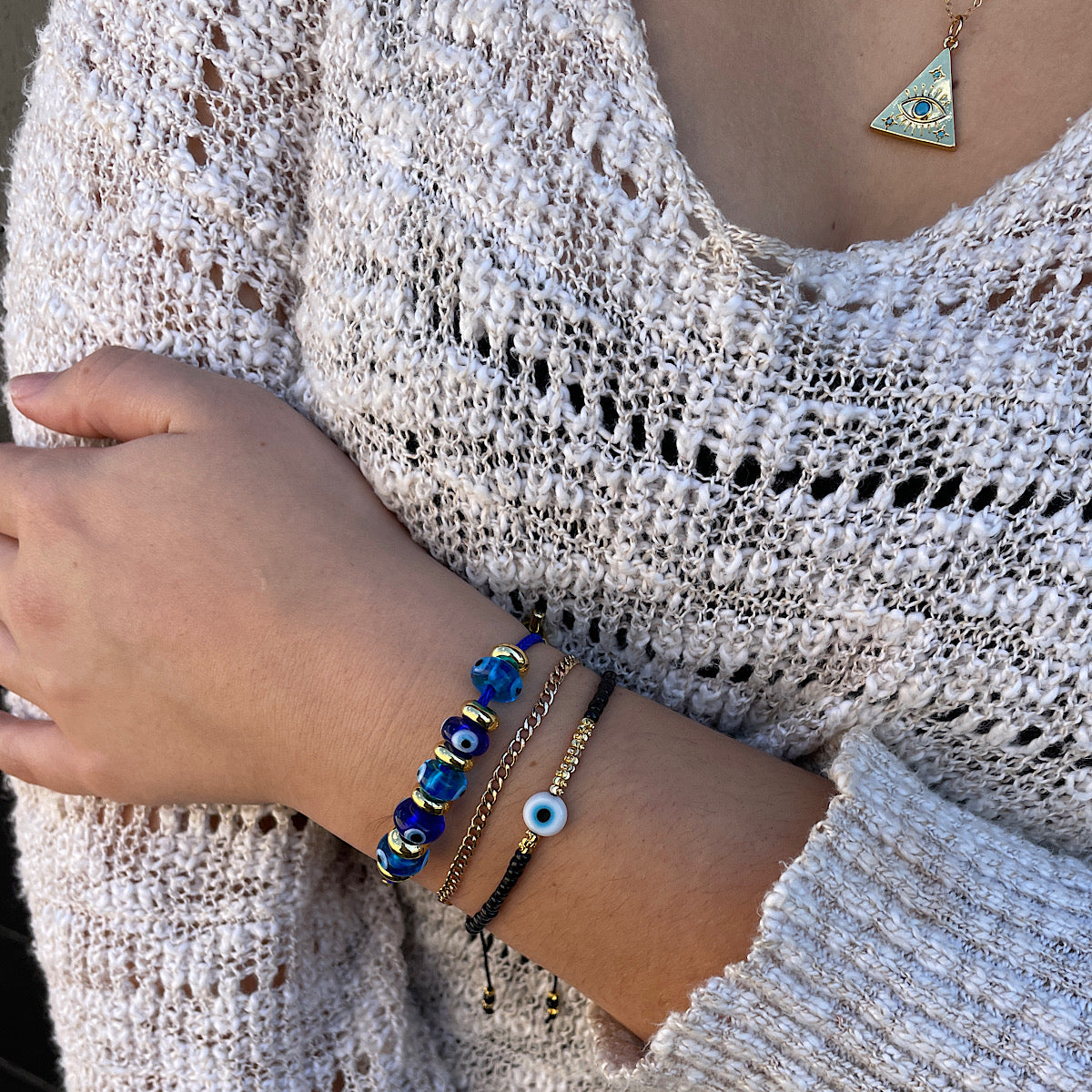 Evil Eye Seed Bead Bracelet with glass eye bead stacked with other bracelets